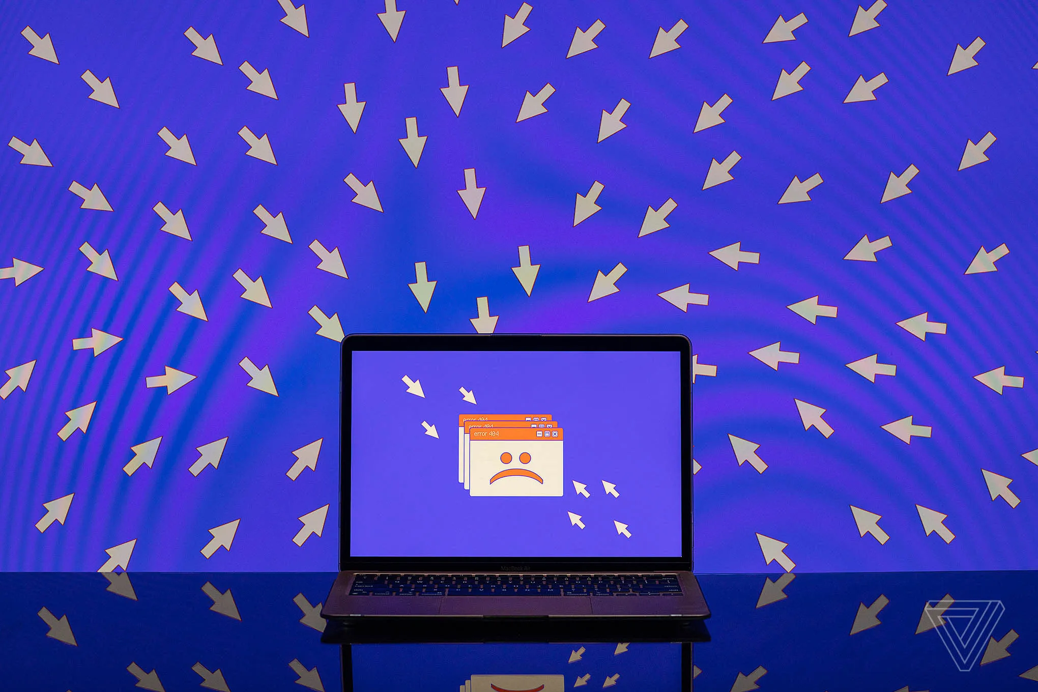 A number of cursors point toward an unhappy face on a laptop